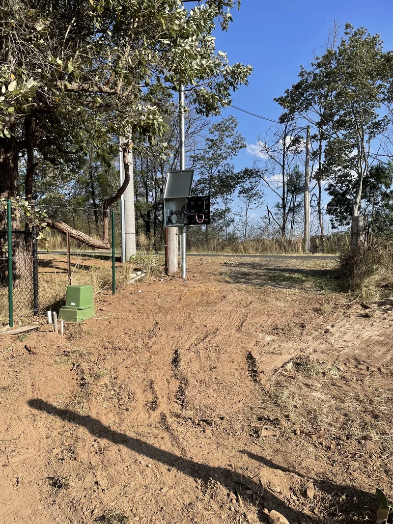 The private pole standing with its meter box fitted and the pit at its base
