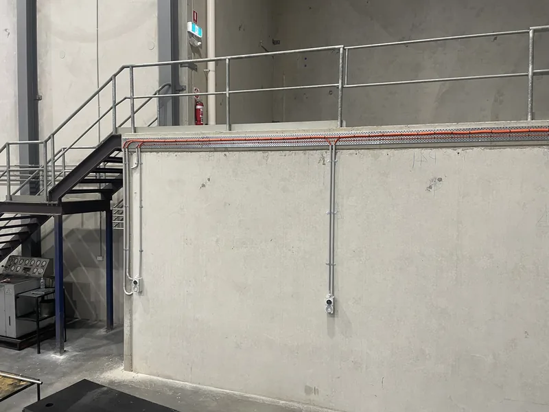 The mezzanine from the floor, with the conduit run and outlets in place