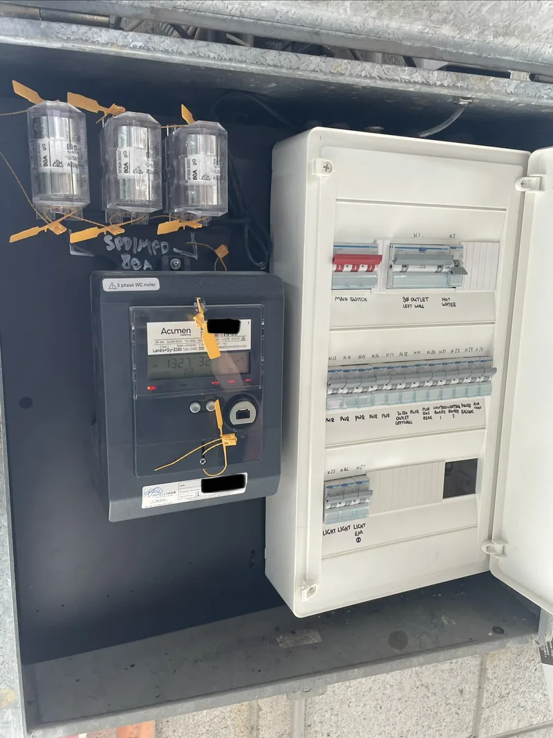 After: the same board rebuilt, with new metering and a labelled row of circuit breakers