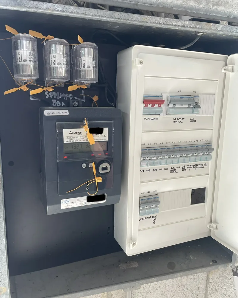After: the same board rebuilt, with new metering and a labelled row of circuit breakers