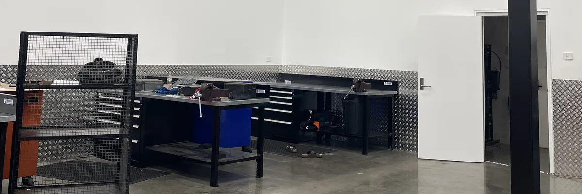 The finished workshop at Smithfield, with benches and shelving under new LED batten lighting